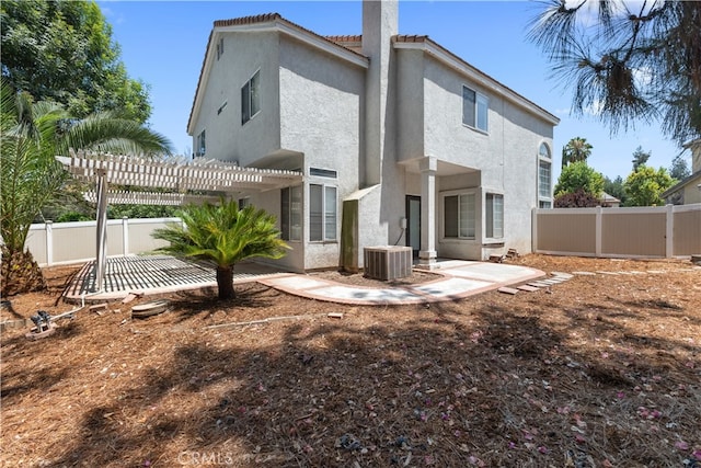 rear view of house with a patio, a pergola, and central air condition unit