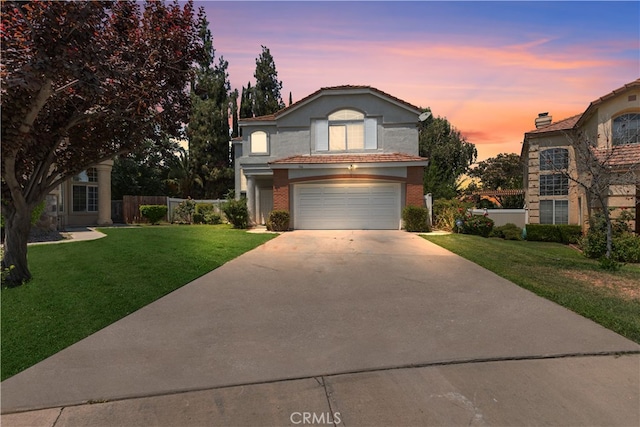 front facade with a yard and a garage