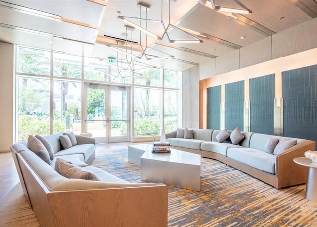 living room featuring floor to ceiling windows and french doors