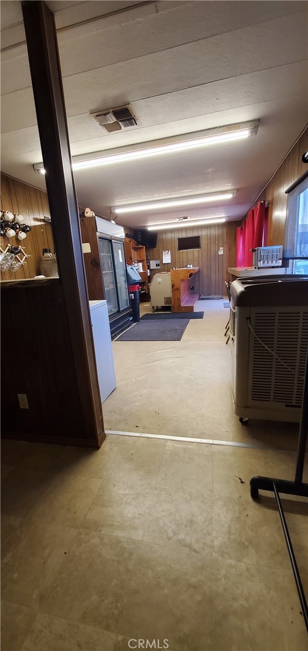 garage featuring wood walls