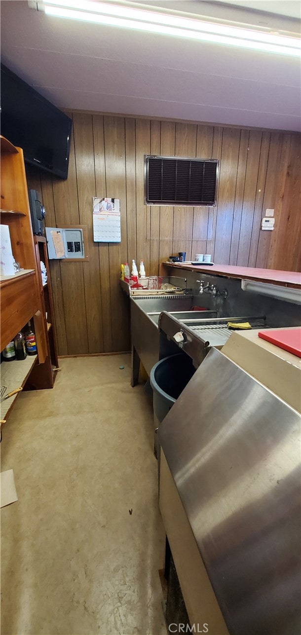 kitchen featuring wood walls