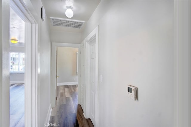 hallway with wood-type flooring