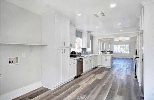 kitchen with light countertops, visible vents, appliances with stainless steel finishes, white cabinetry, and baseboards