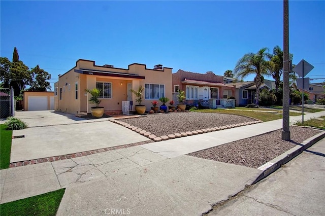 view of front of house with central air condition unit, a garage, an outdoor structure, driveway, and stucco siding