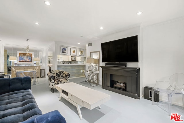 living room with ornamental molding