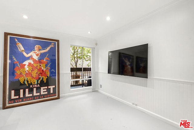 unfurnished living room featuring concrete floors, wooden walls, and crown molding