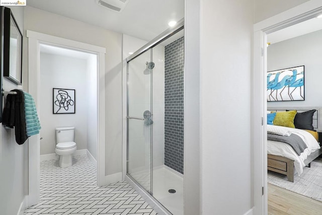 bathroom featuring walk in shower and toilet