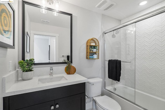 full bathroom with shower / bath combination with glass door, vanity, and toilet