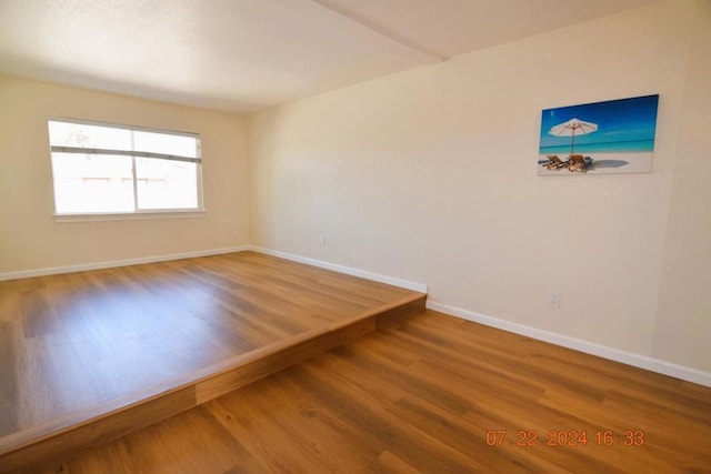 empty room with hardwood / wood-style floors