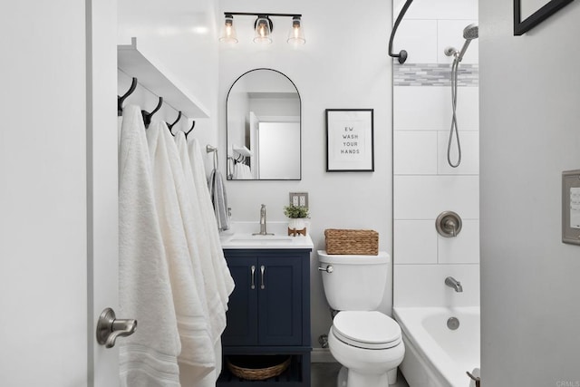 full bathroom featuring tiled shower / bath, toilet, and vanity