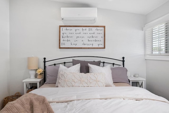 bedroom featuring an AC wall unit