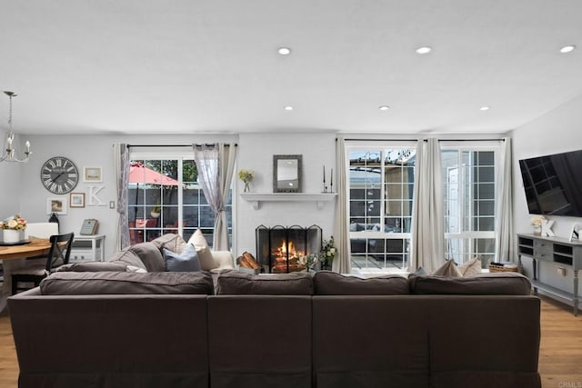 living room featuring light hardwood / wood-style floors and a chandelier