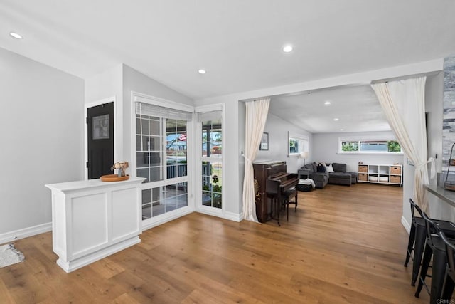 living room featuring light hardwood / wood-style flooring and lofted ceiling