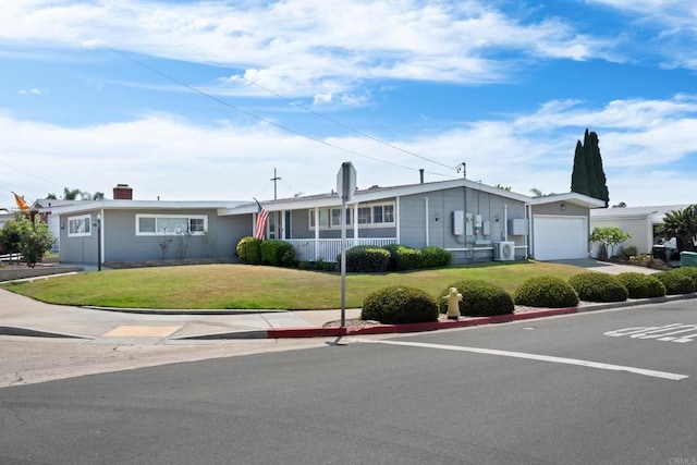 single story home featuring central AC, a garage, and a front lawn