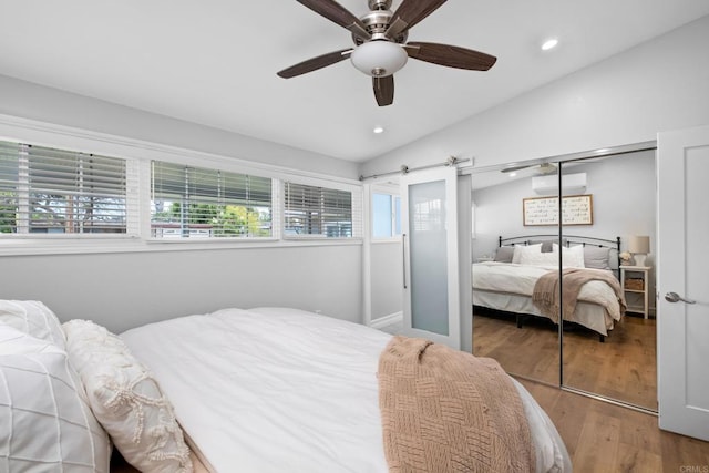 bedroom featuring ceiling fan, vaulted ceiling, hardwood / wood-style flooring, and a closet