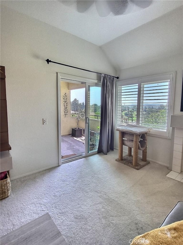 unfurnished living room featuring baseboards, vaulted ceiling, and light colored carpet