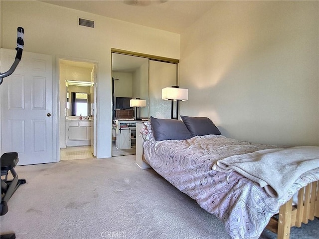 bedroom featuring a closet, carpet, connected bathroom, and visible vents