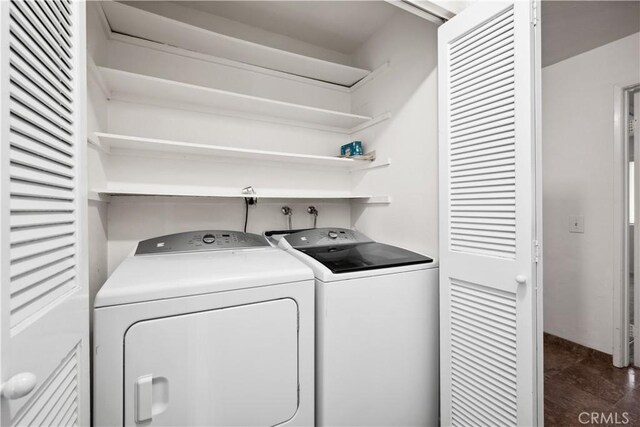 laundry room featuring independent washer and dryer and dark tile patterned floors