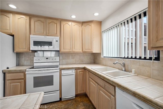 kitchen featuring white appliances, tile counters, and plenty of natural light