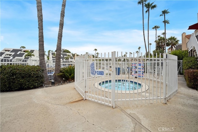 view of swimming pool featuring a community hot tub