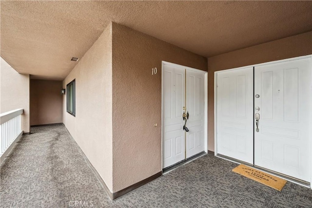 entrance to property featuring stucco siding