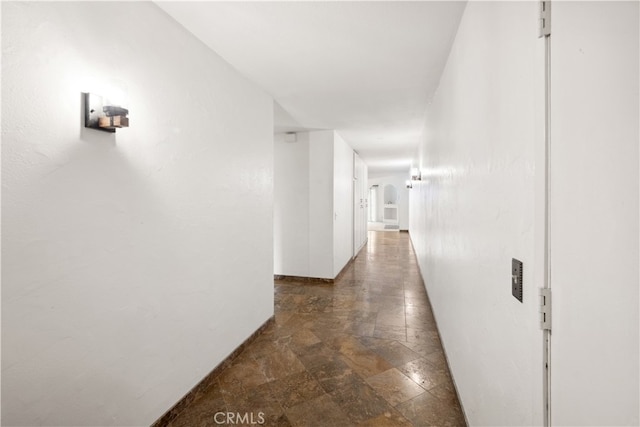 corridor featuring dark tile patterned flooring