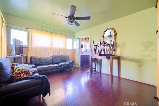 living room with ceiling fan and dark hardwood / wood-style floors