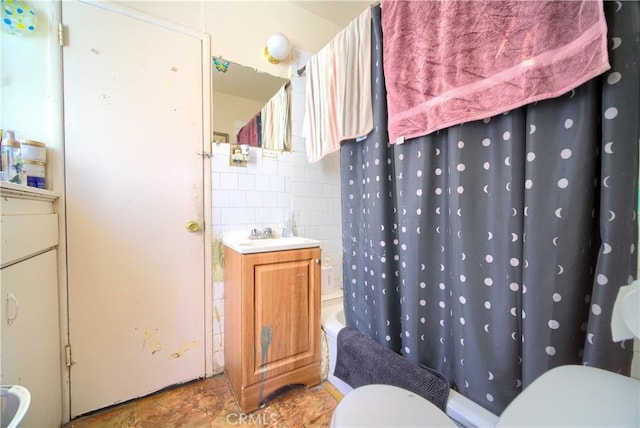 full bathroom with vanity, tasteful backsplash, tile walls, toilet, and shower / bath combo with shower curtain