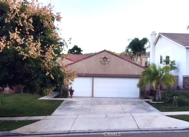 1638 Spyglass Dr, Corona, CA 92883 - view of front of house featuring a garage, driveway, a front lawn, and stucco siding