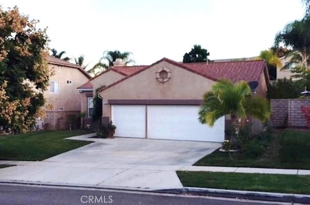 1638 Spyglass Dr, Corona, CA 92883 - mediterranean / spanish-style house featuring an attached garage, concrete driveway, stucco siding, and a front yard