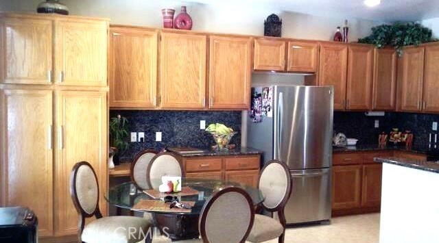 1638 Spyglass Dr, Corona, CA 92883 - kitchen with tasteful backsplash and stainless steel fridge