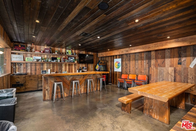 interior space featuring wood walls and bar area