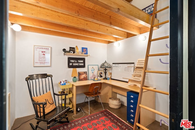 office space featuring beam ceiling and built in desk