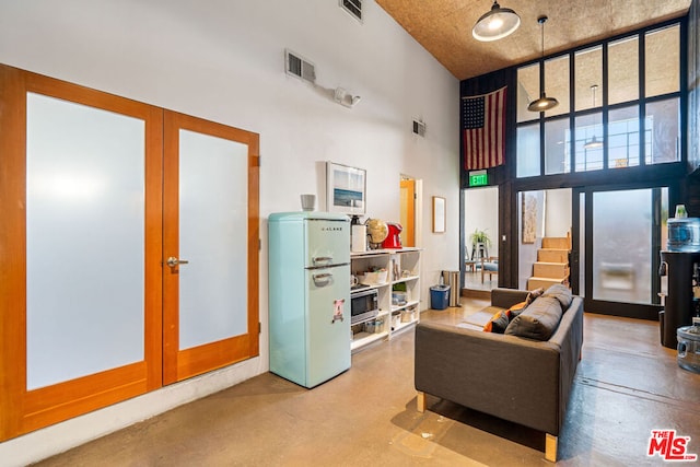 living room with a towering ceiling