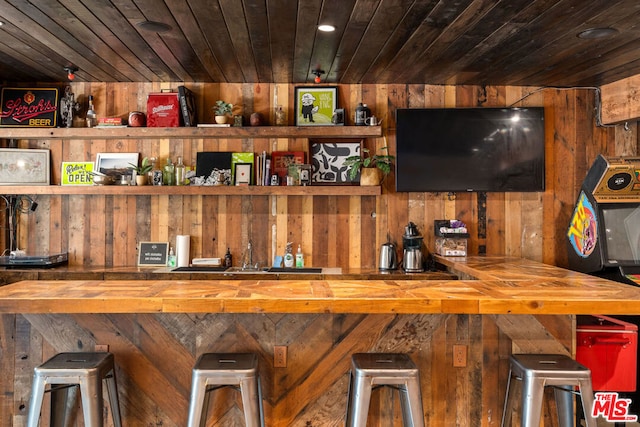 bar featuring wood walls and wooden ceiling