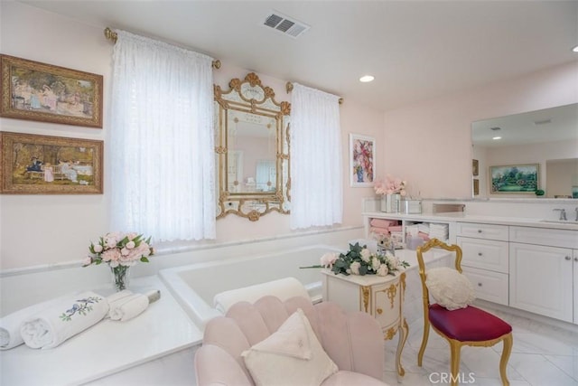 bathroom featuring a washtub and vanity