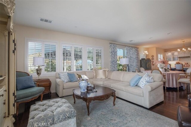 living room with an inviting chandelier and hardwood / wood-style floors