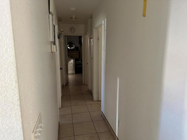 corridor with light tile patterned floors