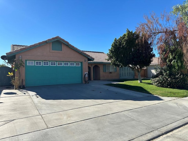 single story home featuring a front lawn and a garage