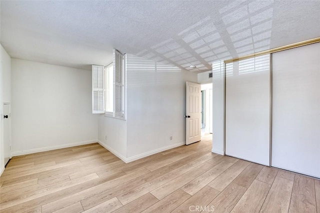 empty room with light hardwood / wood-style flooring