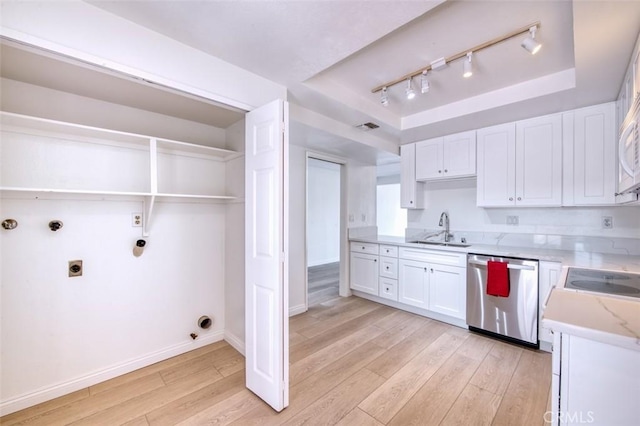 16090 Tortola Cir, Huntington Beach, CA 92649 - kitchen featuring stainless steel dishwasher, a raised ceiling, light wood-type flooring, and white cabinetry