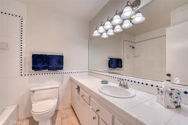 bathroom with tile patterned floors, vanity, toilet, and tile walls