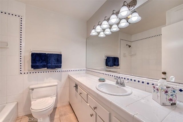 16090 Tortola Cir, Huntington Beach, CA 92649 - full bathroom with vanity, tile patterned flooring, tile walls, and tub / shower combination