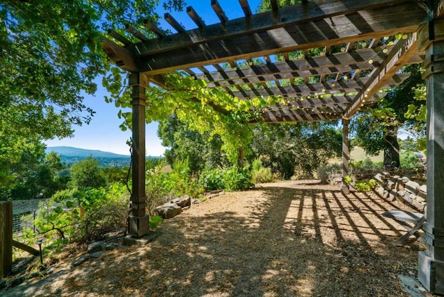 view of yard with a mountain view and a pergola