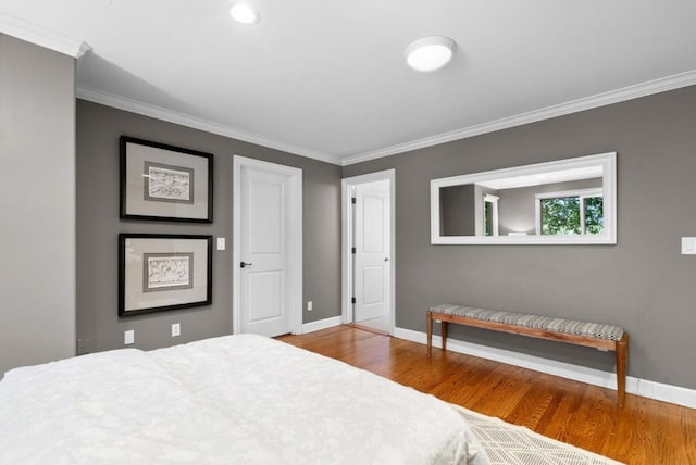 bedroom with hardwood / wood-style flooring and ornamental molding