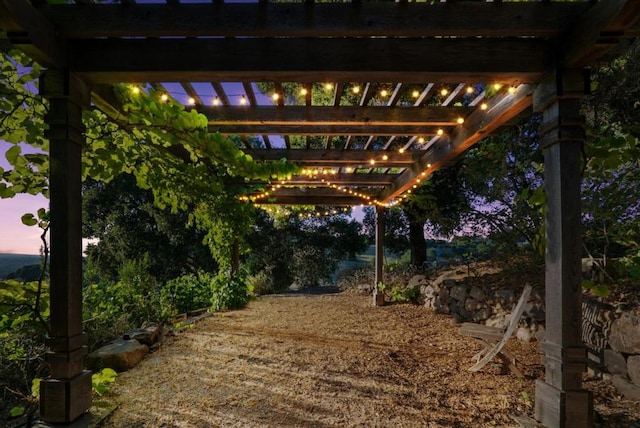 yard at dusk featuring a pergola