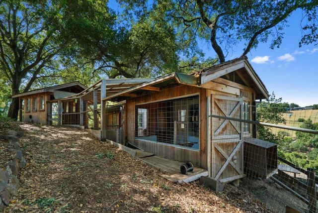 view of home's exterior with an outdoor structure