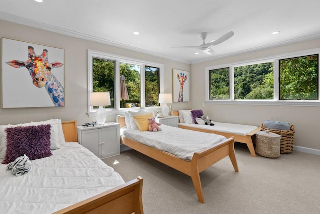 carpeted bedroom with crown molding and ceiling fan