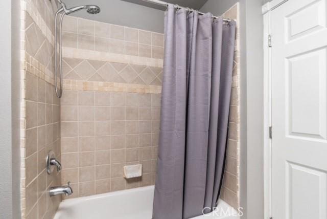 bathroom with shower / bath combo with shower curtain