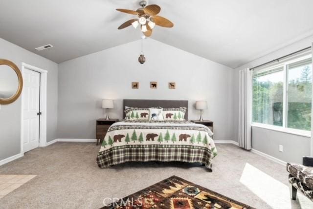 bedroom with ceiling fan, carpet flooring, and vaulted ceiling